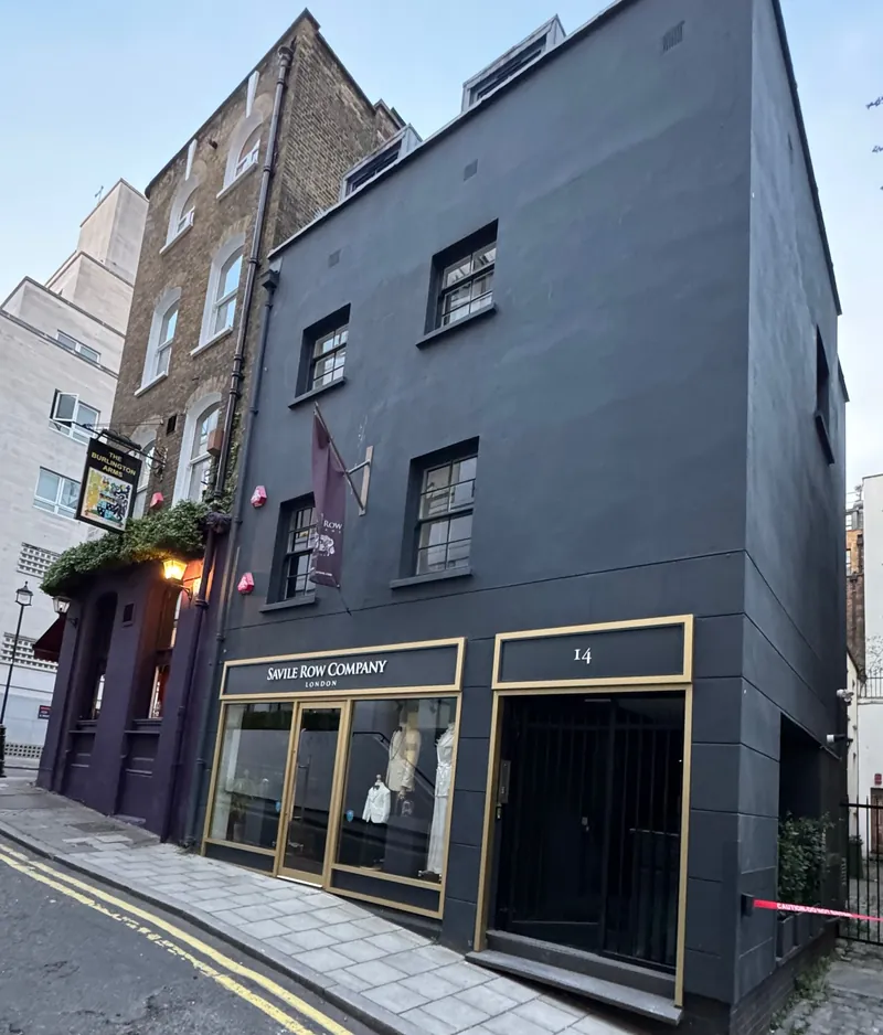 Black-painted period building with shopfronts in Mayfair, home to a flat we renovated