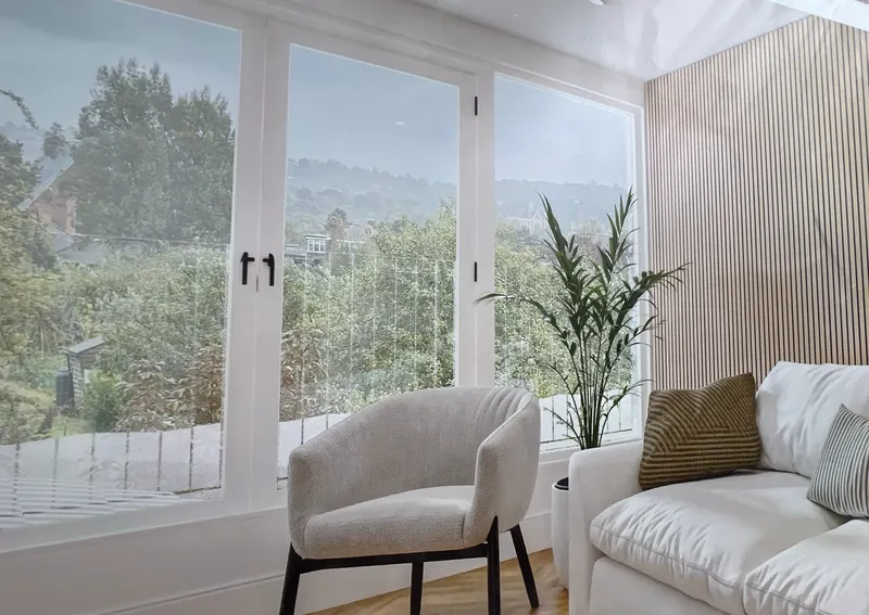 Bright living space with large windows in a Lewisham property being converted into two flats